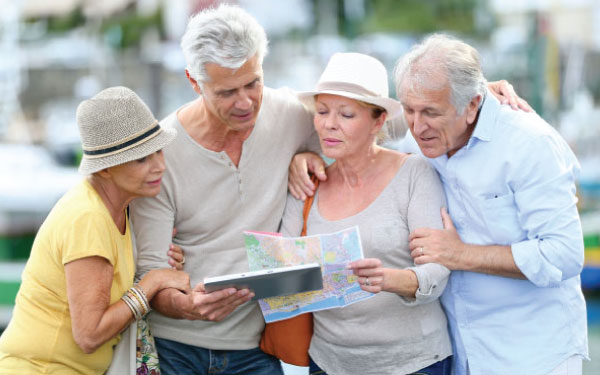 An elderly group looking at a map